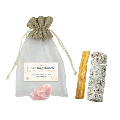 Cleansing bundle with sage, Palo Santo, and crystal on a white background