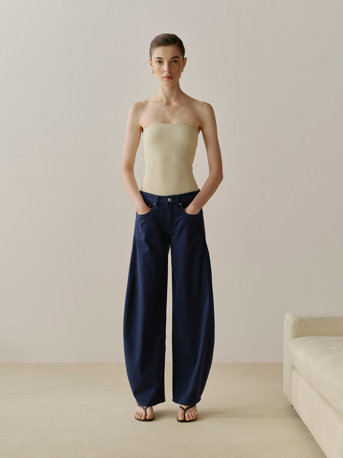 DL1961 women's InstaSculpt Rib tube top in pale cream 'Ecru', front view on model with navy wide-leg jeans.
