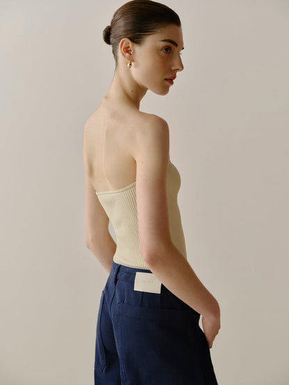 DL1961 women's ribbed tube top in cream 'Ecru', styled with navy trousers, three-quarter back view on model.