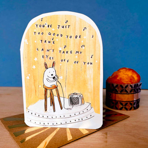 Bunny greeting card with white rabbit on stage and microphone illustration